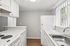 Kitchen at Creekwood with all white appliances and a window over the sink