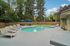 Pool at Creekwood with lounge chairs and tables and chairs