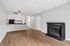 Living Room at Creekwood with a fireplace with black tile around it and a ceiling fan