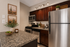 Virtually staged kitchen at solaris at the biltmore with dark cabinets and dark countertops and stainless steel appliances