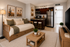 Virtually staged studio apartment with a daybed doubling as a couch, tv and into the kitchen area