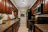virtually staged kitchen at solaris at the biltmore with dark cabinets and brown countertops