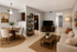 Virtually staged living and dining room with a tv, couch, dining are and bookshelf