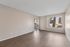 Solaris at Shadow Mountain living room with vinyl plank flooring and sliding glass door to a patio.