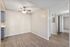 Dining area with wood-style floors and a lighted ceiling fan near the kitchen entrance.
