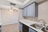 Kitchen at Solaris at Shadow Mountain with blue cabinetry and white countertops overlooking the dining area.