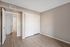 Bedroom featuring neutral walls, wood-style flooring, and a large sliding door closet.