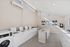 On-site laundry care center with multiple white washers and dryers for resident use.