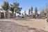 Sand volleyball court at Solaris at Shadow Mountain with surrounding trees and parking area.