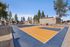 Full-view of the outdoor basketball court with a mountain backdrop.