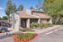 Exterior of the Solaris at Shadow Mountain leasing office with stone accents and landscaping.