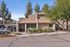 Leasing office exterior showing resident parking and stone-accented architecture.