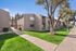 Two-story apartment buildings with stucco exteriors and mature landscaping.