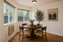 dining atre at corporate woods with a dining table, art, and two windows