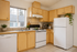 virtually staged kitchen in a studio unit at corporate woods apartments with white appliances and decor