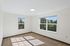 Solthea Apartments bedroom with two windows and hardwood floors