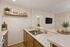 Virtually staged kitchen at Orchard mesa with wood floors, white countertops and wood cabinets