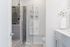 Elegant modern bathroom featuring a luxurious glass-enclosed shower, sleek cabinetry with ample storage, and bright, contemporary decor for a refreshing ambiance.