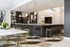 Elegant apartment interior featuring a contemporary kitchen with a spacious island, stylish pendant lights, and modern bar stools, complemented by a large dining table with chic metal chairs for a luxurious setting.