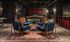 Chic lounge area with velvet blue chairs, vibrant Persian rug, and industrial décor, perfect for sophisticated gatherings.