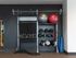 Modern fitness corner with a sleek equipment rack, yoga mats, exercise balls, and kettlebells, perfect for home workouts.
