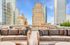 Luxurious rooftop lounge with plush seating and stunning cityscape views, perfect for relaxation in an urban oasis.