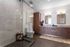 Elegant modern bathroom with dual sinks, large glass shower, and stylish wood cabinetry.