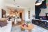 Modern living space with open-concept kitchen, elegant dining area, and stylish decor, highlighting contemporary lighting and artistic wall accents.
