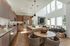 Elegant open-concept living space with high ceilings, modern kitchen, and cozy seating area bathed in natural light.