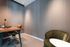 Modern and cozy office space with a sleek wooden desk, comfortable swivel chair, and stylish accent lighting, ideal for productivity and inspiration.