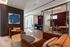 Contemporary office space with plush seating, modern glass partitions, and cozy meeting nooks.
