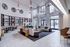 Luxurious apartment lobby featuring chic seating areas, modern decor, and expansive windows inviting natural light.