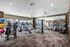 Luxurious apartment gym with state-of-the-art fitness equipment, mirrored walls, and ample natural light.
