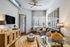 Modern living room featuring a cozy sofa, chic decor with stylish lighting, and sleek contemporary furniture, creating an inviting atmosphere.