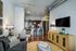 Contemporary living space featuring sleek kitchen, cozy seating area, and modern decor with ample lighting.