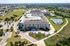 Cedar Park apartment community from above with retention pond, walking path, and surface parking