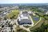 Cedar Park apartment community from above with pond, walking trail, parking lot, and retail corridor