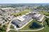 Cedar Park apartment buildings with pond, walking trail, and nearby retail corridor