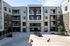 Apartment building exterior in Cedar Park with brick facade, private balconies, and resident parking