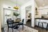 Dining area with pendant light, patio doors, breakfast bar stools, and wood plank flooring
