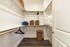 Walk in closet with wood shelving, double hanging rods, and wood plank flooring