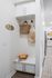 Entry drop zone with built in bench, storage cabinets, coat hooks, and wood plank flooring