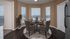 Dining area with round table, four chairs and bay windows
