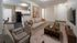 Living room with sofa, coffee table and view into the kitchen