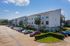 Three-story building with parking lot and landscaped island, Houston, TX
