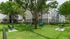 Dog park with agility equipment, tunnel and shade trees