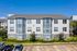 Three-story building with bay windows, landscaping and parking, Houston, TX