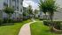 Walking path with lawn, shade trees and three-story buildings, Houston, TX