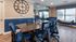 Conference room with wall clock, meeting table and blue chairs