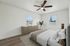 Bright and inviting bedroom with modern decor, featuring wood floors, a large dresser, and scenic views through ample windows.